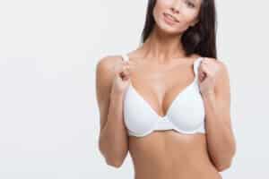 Woman wearing a bra showing her youthful breasts from breast lift surgery in San Antonio, TX